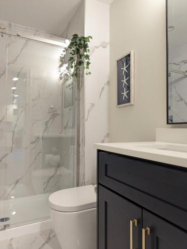 a bathroom with a shower and a toilet and a sink at Nice home away at Vancouver near YVR in Vancouver