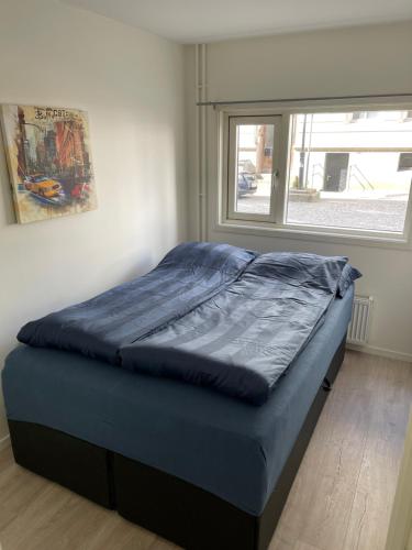 a bed sitting in a room with a window at Very central location in Bergen in Bergen