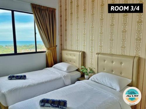 a hotel room with two beds and a window at Sky2Sea Penthouse @ Icon Residences in Kuala Terengganu