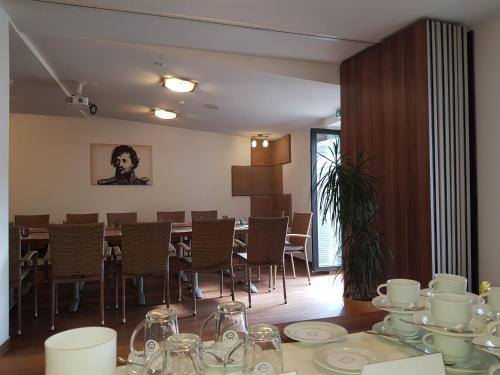 a dining room with a table with dishes on it at Hotel-Restaurant Pfälzer Hof in Edenkoben