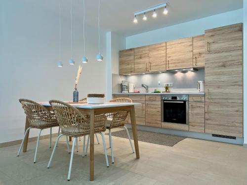 a kitchen with a table and chairs in a room at Design Apartment Alpenvorstadt in Holzkirchen