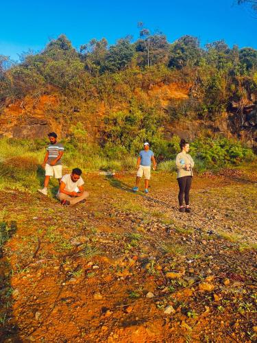 a group of people walking on a dirt road at Gregory House Hostel in Nuwara Eliya