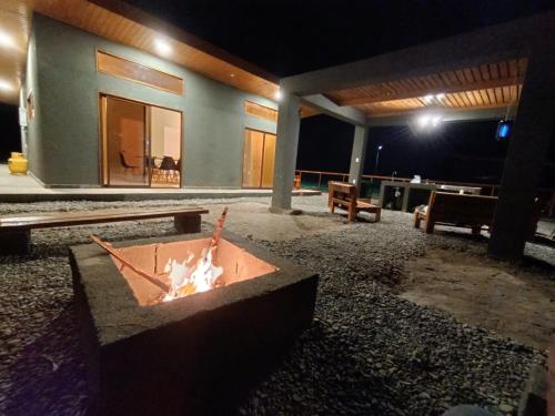 a fire pit in front of a house at night at Cabañas Nonito in Pozo Almonte