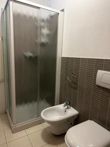 a bathroom with a shower and a toilet and a sink at Residence La Settima in Milano Marittima