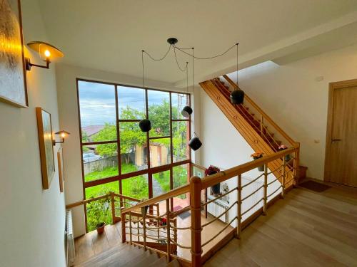 a room with a staircase and a large window at Hestia - Hotel, Wine and View in Tʼelavi