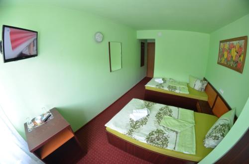 a small room with two beds in it at Hotel Le Baron in Timişoara