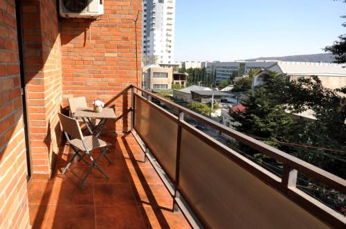 a balcony with a table and chairs on a building at Hotel Majestic in Tbilisi City