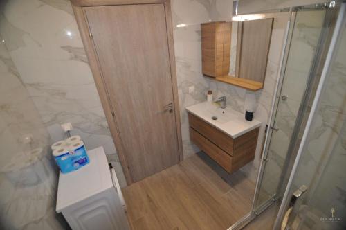 a small bathroom with a shower and a sink at Zennova #24, FLOW Nikiti Family Apt in Nikiti