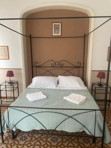 a bedroom with a bed with two towels on it at casa san Pietro in Rome
