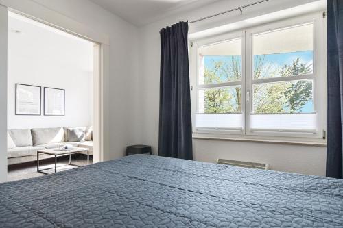 a bedroom with a bed and a large window at Baltic Suite 16 in Stakendorfer Strand
