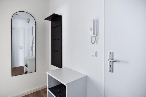 a bathroom with a mirror and a white sink at Baltic Suite 16 in Stakendorfer Strand
