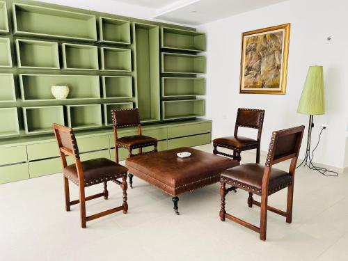 a room with green shelves and a table and chairs at Olea Vitis in Međugorje