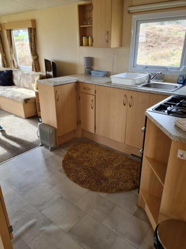 a kitchen with a sink and a stove at Loch Heron View in Newton Stewart
