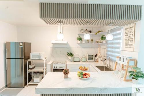 a kitchen with a bowl of fruit on a counter at DGM AirBnB Urdaneta Pangasinan 