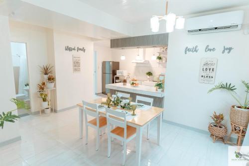 a kitchen and dining room with a table and chairs at DGM AirBnB Urdaneta Pangasinan in Bayaoas