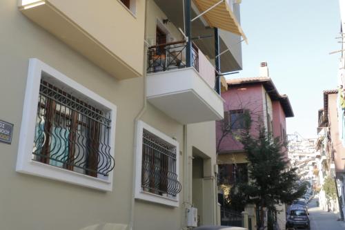 two windows on a building with bars on them at Helen's Little Castle free private parking in Thessaloniki