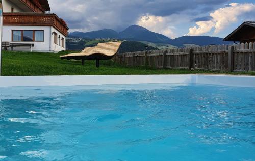 a swimming pool in front of a house at Der Brunnerhof in Mühlbach