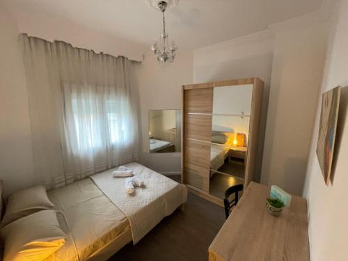 a bedroom with a bed and a mirror and a table at Studio 7 in Thessaloniki
