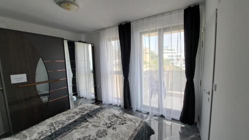a bedroom with a bed and a large window at Diamond Beach Luxus Apart Obzor 28 in Obzor