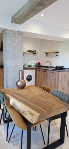 a kitchen with a wooden table and a stove at A Pasturella, Jacuzzi Spa in Venzolasca
