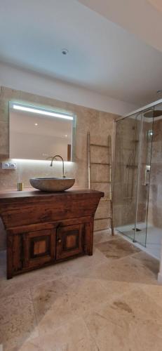 a bathroom with a sink and a mirror at A Pasturella, Jacuzzi Spa in Venzolasca