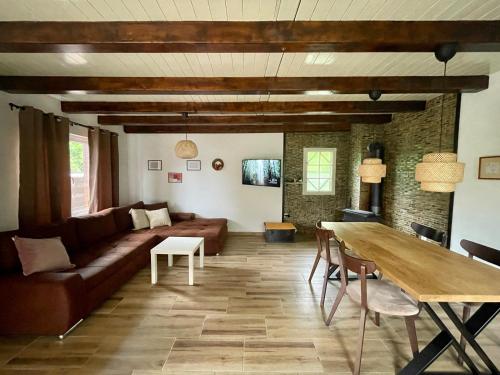 a living room with a couch and a table at Buzzing Retreat in Velika Remeta