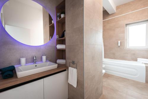 a bathroom with a sink and a mirror at Mountain Breeze ApartTerrace in Braşov