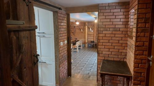a brick hallway with a door and a brick wall at Agroturystyka Cisza Knyszyńska in Wólka