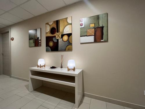 a room with paintings on the wall and a table at AFFITTACAMERE POPLETUM in Coppito