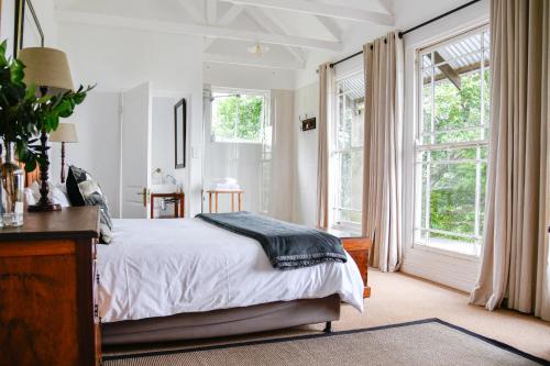 a bedroom with a bed and a large window at The Knoll Historic Guest Farm in Hilton