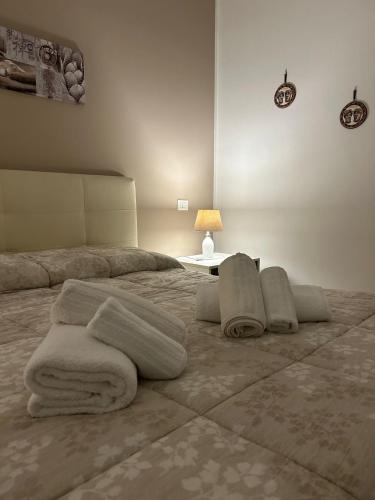 een slaapkamer met een bed met handdoeken erop bij Lucia's Rooms in Siracusa