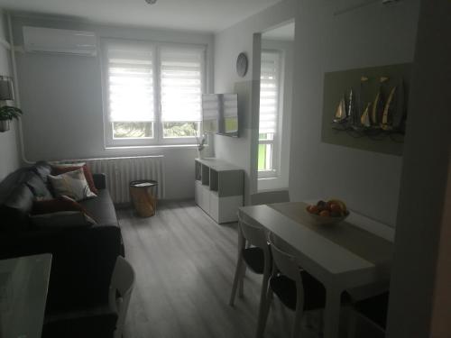 a living room with a couch and a table at RsG Home in Keszthely