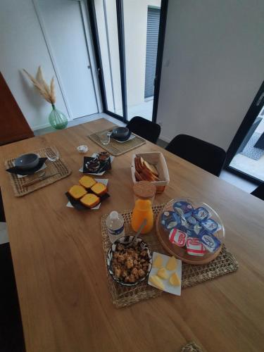 a table with a bunch of food on it at Chambres près du circuit in Changé