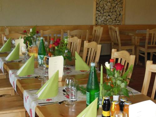 a long table with green napkins and flowers on it at Alpengasthof Fernblick in Mönichkirchen