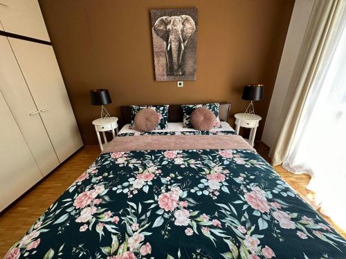 a bedroom with a bed and an elephant picture on the wall at Apartma Zonta in Sečovlje