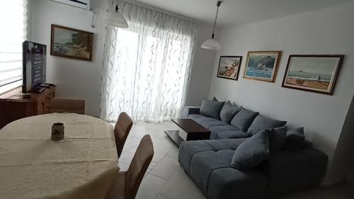a living room with a couch and a table at Lustica-Apartment Dora3 in Herceg-Novi
