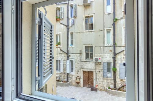 a window with a view of a building at Irini Luxury Rooms in Split