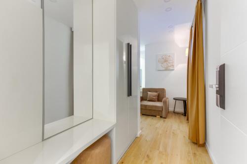 a hallway with white walls and a living room at Irini Luxury Rooms in Split