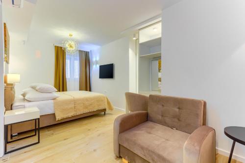 a bedroom with a bed and a couch at Irini Luxury Rooms in Split