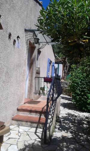 un banc en bois installé à côté d'un bâtiment avec des escaliers dans l'établissement La Figounette du soleil, à Le Revest-le-Eaux
