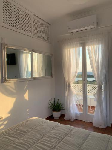 a bedroom with a bed and a sliding glass door at Sea and Salt Naxos 3 in Kastraki Naxou