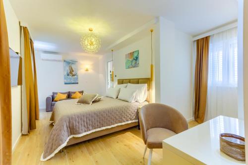 a bedroom with a bed and a chair in it at Irini Luxury Rooms in Split
