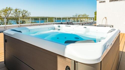a hot tub on the roof of a house at Apartamenty Stranda Residence nad jeziorem Mazury Holiday in Giżycko