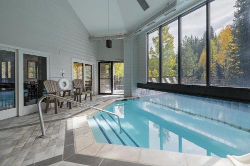 a swimming pool in a house with windows at Iron Horse C5013 condo in Winter Park