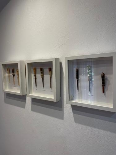 two white display cases on a wall with swords at Apartamento vacacional in El Pont de Suert