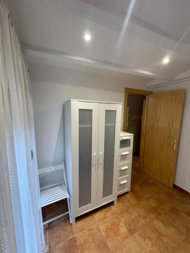 a room with a white cabinet in a room at Apartamento vacacional in El Pont de Suert