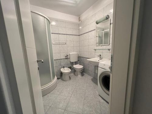 ein Badezimmer mit einem WC, einem Waschbecken und einer Waschmaschine in der Unterkunft Apartment Gabi in Split