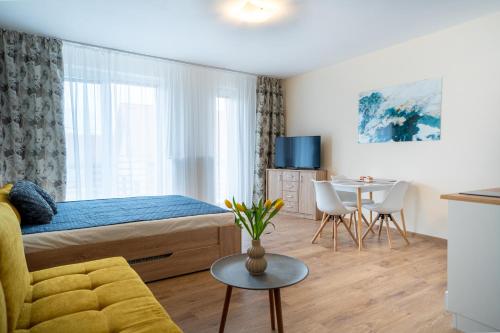 a small bedroom with a bed and a table at Ubytovanie Biely dom in Turčianske Teplice