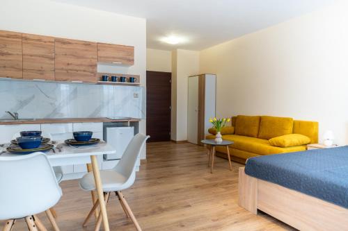 a bedroom with a bed and a table and a couch at Ubytovanie Biely dom in Turčianske Teplice