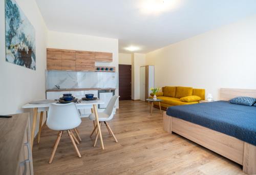 a bedroom with a bed and a table and chairs at Ubytovanie Biely dom in Turčianske Teplice